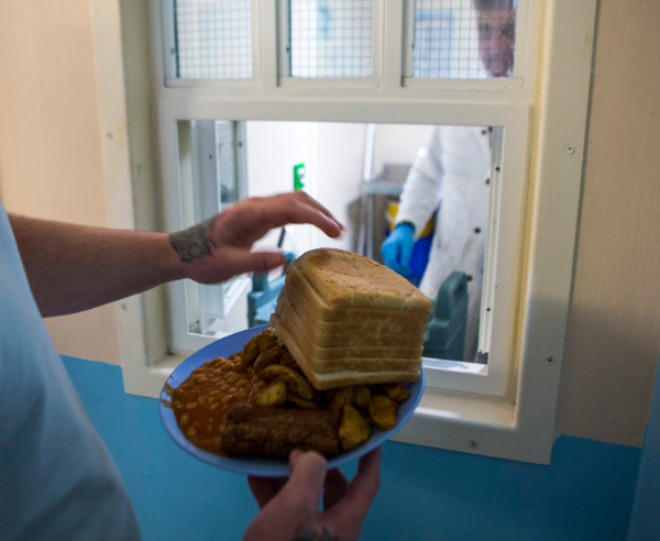 Introducing 'Food Matters in Prison'. Picture of a prisoner getting 7 slices of bread to go with his eggs, chips and beans. This was at Beaufort House, a skill development unit for enhanced prisoners. Part of HMP/YOI Portland, a resettlement prison with a capacity for 530 prisoners. Dorset, Unit